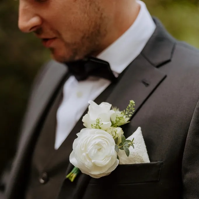 Elevate the groom's ensemble with a tastefully crafted floral boutonniere.